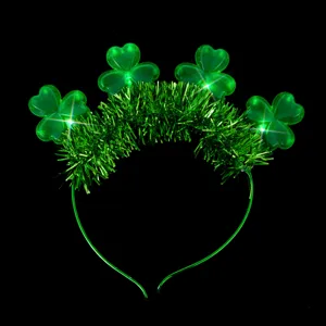 Close-up detail view of green shamrock headband with sparkly tinsel for Irish festival wear.