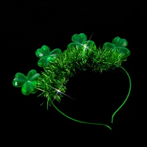 Green shamrock headband detail close-up showing glowing tinsel and festive St Patrick decor.
