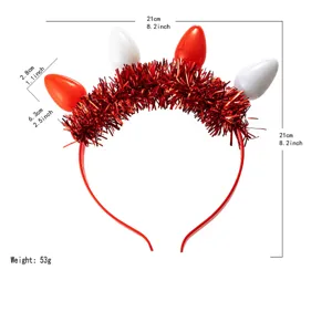 Red tinsel headband detail view, festive bulb decoration, lightweight holiday party hair accessory.