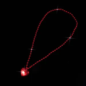Red LED glowing heart pendant necklace with beaded chain, perfect for Valentine's Day party.