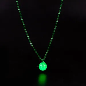 Detailed close-up of a green glowing bead necklace, bright light-up sphere pendant for parties.