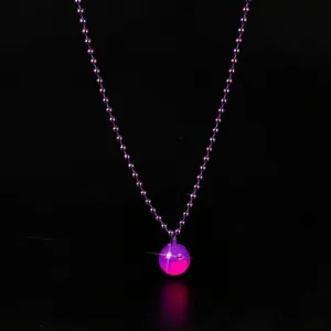 Detailed view of the glowing purple bead necklace with light-up spherical pendant for events.