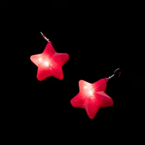 Glowing red star earrings detail, illuminated star pendant close-up, unique party jewelry.
