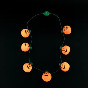 Halloween glowing pumpkin necklace detail shot, featuring seven orange jack-o'-lantern lights.