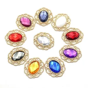 Close-up detail of colorful rhinestone cabochons in gold filigree metal bases for DIY crafts.