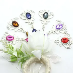 Close up detail of diy alloy crown pendant floral corsage with colorful crystal rhinestones.