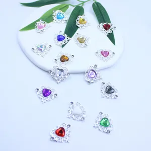 Detailed close-up shot of heart-shaped rhinestone alloy DIY jewelry charms with colorful gems.