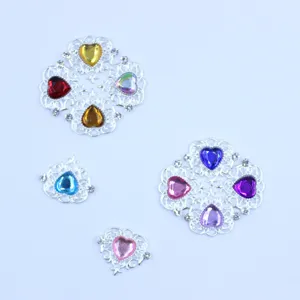 Close-up of heart rhinestone alloy DIY jewelry accessories, delicate silver openwork details.
