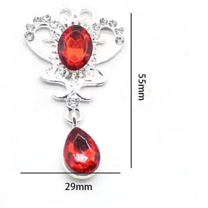 Alloy crown rhinestone pendant detail, featuring red gemstone and clear crystal embellishments.
