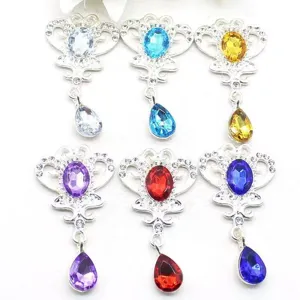 Close-up detail shot of alloy crown rhinestone pendant charms, colorful crystal DIY findings.