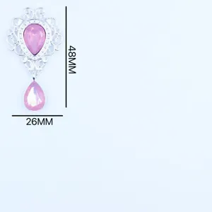 Silver alloy filigree pendant detail featuring delicate hollow work and pink teardrop stone.
