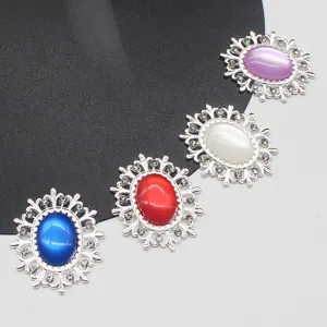 Close-up of oval hollow alloy resin cat eye rhinestone buttons for DIY hair accessories