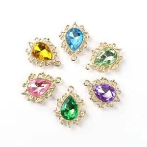 Closeup of colorful teardrop acrylic rhinestone alloy charm pendants for DIY jewelry making.