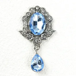 Close-up detail of vintage baroque blue rhinestone brooch pendant DIY fashion jewelry accessory.