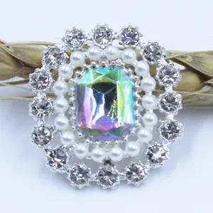 Close-up of shiny alloy rhinestone flower button with pearls for DIY crafts and hair accessories.