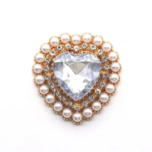 Detail shot of heart-shaped alloy rhinestone button with pearls for DIY bags, clothes and jewelry.