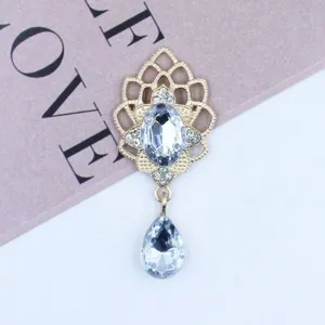 Detailed view of the golden alloy rhinestone pendant accessory, sparkling crystal teardrop design.
