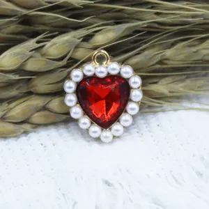 Close-up detail of the red heart pearl alloy pendant accessory for DIY jewelry making.