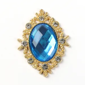 Close-up detail of vintage gold alloy rhinestone button with blue crystal for DIY crafts.