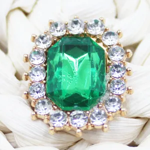 Crystal rhinestone DIY patch detail shot, green gem metal button for shoes and hair accessories.
