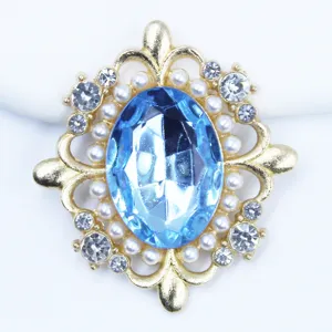 Gold alloy rhinestone acrylic DIY hair accessory flower tray with blue oval gem and pearls.