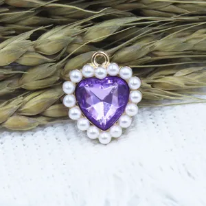 Detail shot of purple heart gem pendant with pearl border, DIY jewelry making accessory.