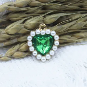 Alloy heart pendant with green crystal and pearl border DIY jewelry making accessory crafting.