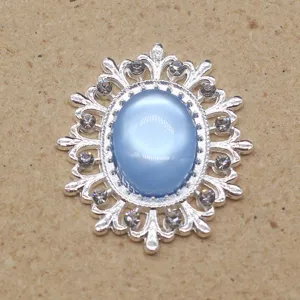 Close-up detail of vintage oval alloy rhinestone resin cat eye decorative button accessory.