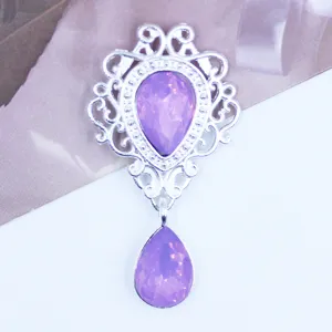 Silver hollow shield pendant detail shot, metal alloy DIY accessory with light purple rhinestones.