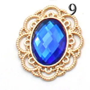 Gold filigree metal base with blue acrylic gemstone DIY craft jewelry accessory detail close up