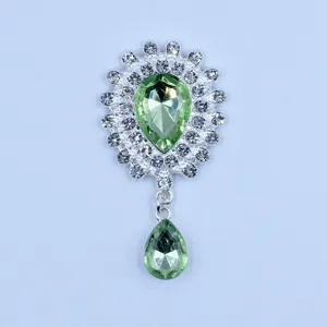 Close-up detail of silver alloy rhinestone green crystal pendant accessory for DIY crafts.