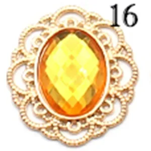 Hollow gold tone metal yellow acrylic stone jewelry accessory detail, DIY craft piece.
