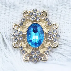 Detailed close-up of a gold-tone alloy rhinestone flower button with a blue center gem.