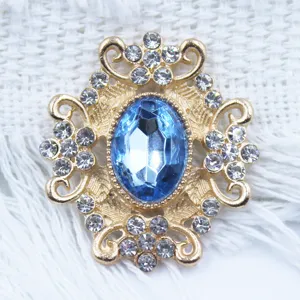 Detail view of vintage gold alloy rhinestone flower button for DIY crafts and apparel.