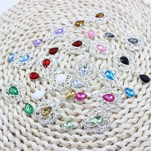 Detail shot of colorful alloy rhinestone flower teardrop pendant charms for DIY craft accessories.