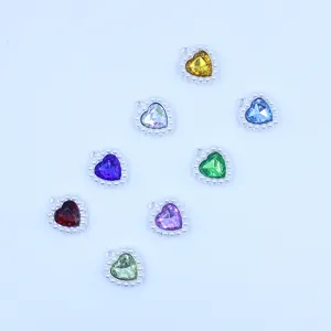 Close-up of 18mm alloy heart crystal charm with pearl border for DIY jewelry making.
