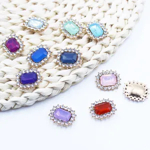 Close-up of rectangular rhinestone alloy crystal buttons, DIY craft jewelry accessory detail.