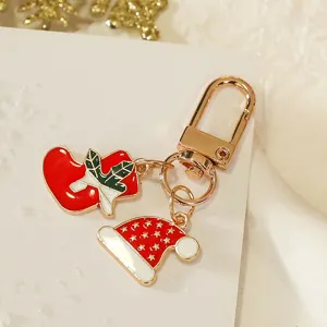 Christmas keychain metal pendant with cute stocking and Santa hat charms for holiday gift.