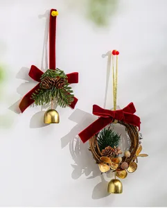 Close-up detail of handmade Christmas hanging wreath and ornament with velvet bow and bells.