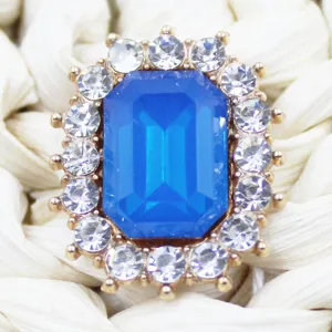 Close-up detail of rectangular blue rhinestone alloy crystal button decoration accessory.