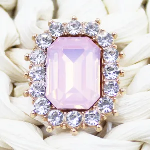 Detailed shot of rectangular pink crystal rhinestone button for DIY crafts and hair accessories.