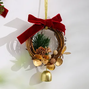 Christmas wreath decoration with red velvet bow, pine cones, and gold bell for tree hanging