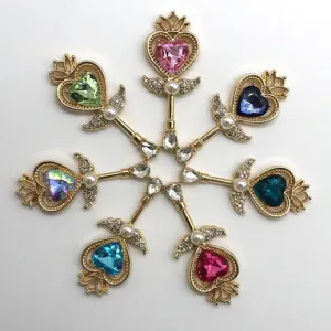 Close-up of baroque heart magic scepter alloy pendants, colorful crystal DIY jewelry parts.