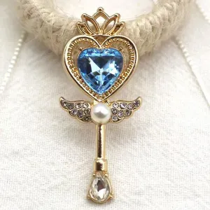 Close-up detail view of the heart magic wand alloy pendant with sparkling blue crystal gem.