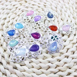 Colorful teardrop acrylic rhinestones with silver alloy hollow base for DIY crafts and accessories.