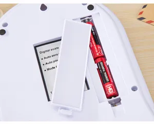 Digital kitchen scale replacement battery compartment detail view, white electronic food scale.