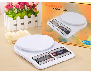SF400 electronic kitchen scale detail view, white plastic body with round tray and LCD display screen.