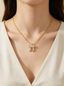 Close up view of gold Hebrew Chai pendant necklace with sparkling cubic zirconia stones.