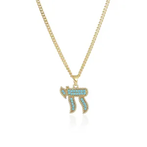 Detailed close-up shot of the Hebrew Chai pendant necklace featuring vibrant turquoise stones.