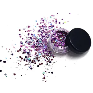Detailed view of sparkling purple holographic cosmetic glitter in small jar with scattered flakes.